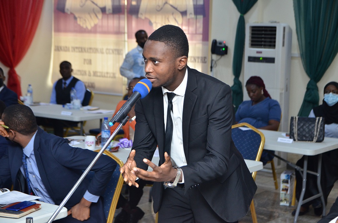 A young lawyer asking a question during the session.